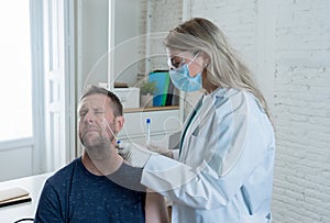 Doctor testing scared adult man for coronavirus infection performing nasal swab, PCR COVID-19 test