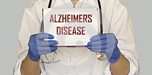 Doctor with text on paper Alzheimer`s disease.