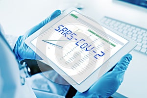 Doctor and the text SARS-CoV-2 in a tablet