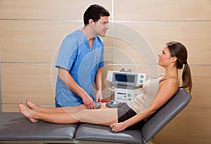 Doctor therapist checking muscle electrostimulation to woman