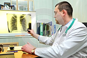 Doctor throwing a look to a chest x-ray image