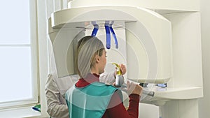 Doctor to take a image 3dx-ray machine 3d digital scanner tomography of teeth and jaw in modern laboratory dental clinic