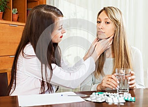 Doctor touching gizzard of female patient