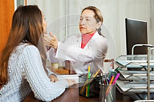 Doctor touching gizzard of female patient