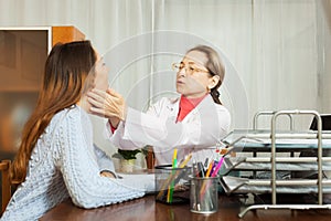 Doctor touching gizzard of girl