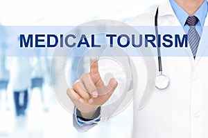 Doctor touching MEDICAL TOURISM sign on virtual screen