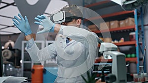 Doctor touching virtual interface in vr goggles working laboratory close up.