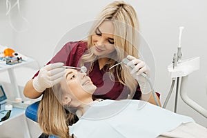 Doctor treats a patient teeth with dental drill. Orthodontist and prosthetics appointment. Hygiene and teeth healthy