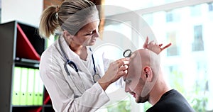 Doctor trichologist examining scalp of bald male patient 4k movie slow motion