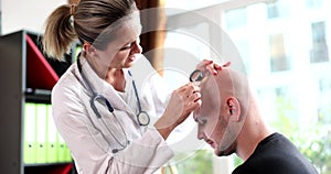Doctor trichologist examining skin on head of bald man 4k movie slow motion