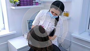 Doctor trichologist making injections mesotherapy in woman head to cure hairs.