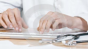 Doctor typing on computer