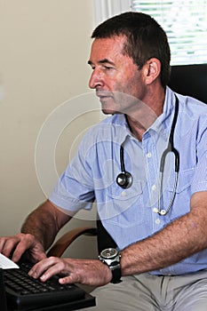 Doctor Typing On A Computer