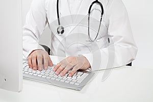 Doctor typing on computer