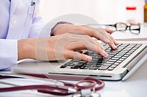 Doctor typing on computer