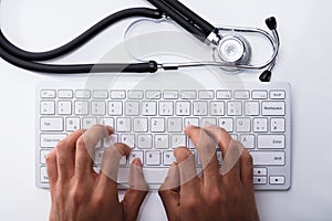 Doctor Typing On Computer Keyboard