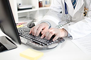 Doctor typing on a computer keyboard