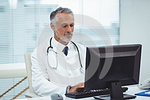 Doctor typing on his computer