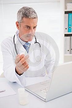 Doctor typing on keyboard the prescriptions photo