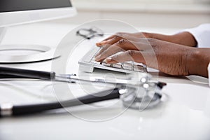 Doctor Typing On Keyboard With Stethoscope
