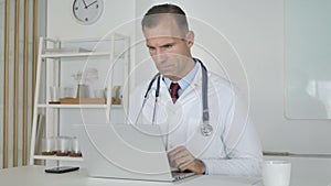 Doctor Typing On Laptop in Clinic