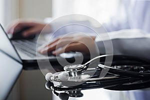 Doctor typing on laptop computer, online medical, telehealth  concept