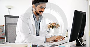 Doctor typing and using his computer