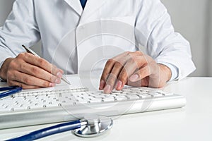 Doctor typing on wireless computer keyboard