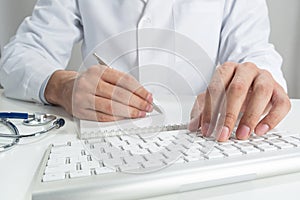 Doctor typing on wireless computer keyboard