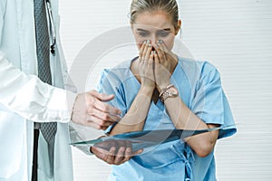 Doctor and unhappy patient at hospital or medical clinic photo