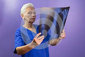 Doctor in a uniform examining the chest x-ray