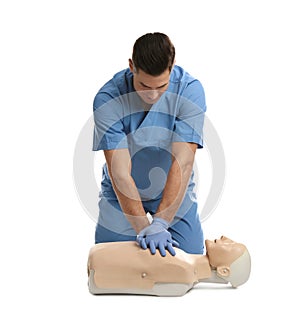 Doctor in uniform practicing first aid on mannequin against white background