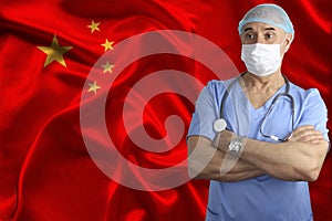 Doctor in uniform with a stethoscope and a mask on the background of the silk national flag of China, the concept of medical care