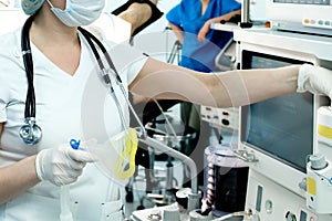 A doctor urgently prepares artificial lung ventilation equipment for a patient with a coronavirus photo
