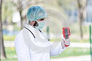 Doctor Use Infrared Thermometer to Check Body Temperature