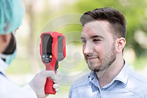 Doctor Use Infrared Thermometer to Check Body Temperature