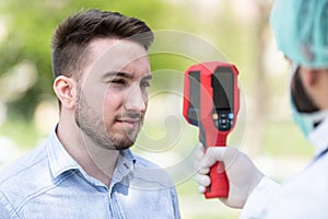 Doctor Use Infrared Thermometer to Check Body Temperature