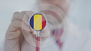 Doctor uses stethoscope with the Romanian flag. Healthcare in Romania