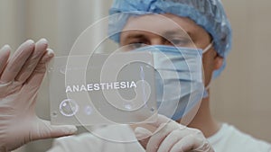 Doctor uses tablet with text Anaesthesia