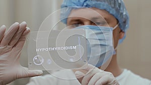 Doctor uses tablet with text Hypothyroidism