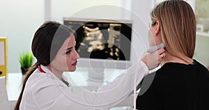 Doctor uses an ultrasound machine to examine patient neck