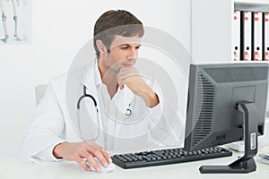 Doctor using computer at medical office