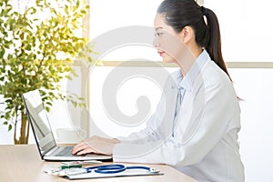 Doctor using computer to research internet, healthcare and medic