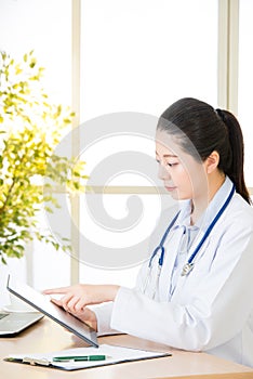 Doctor using digital tablet to recording patient`s medical case