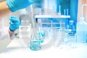 Doctor using electronic pipette for taking samples from test tube