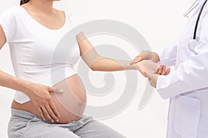 Doctor using hands touching for examining pregnant woman in clinic. Doctor check up eight month pregnant preparing for the child