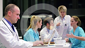 Doctor using laptop in conference room