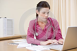 Doctor using laptop in doctor's office