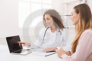 Doctor using laptop and electronic medical record system