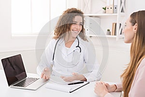 Doctor using laptop and electronic medical record system
